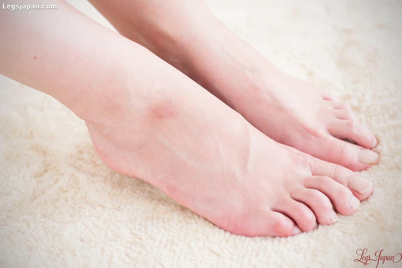 Soft soles and rounded heels highlighted, artistic crop, premium close-up feet photo