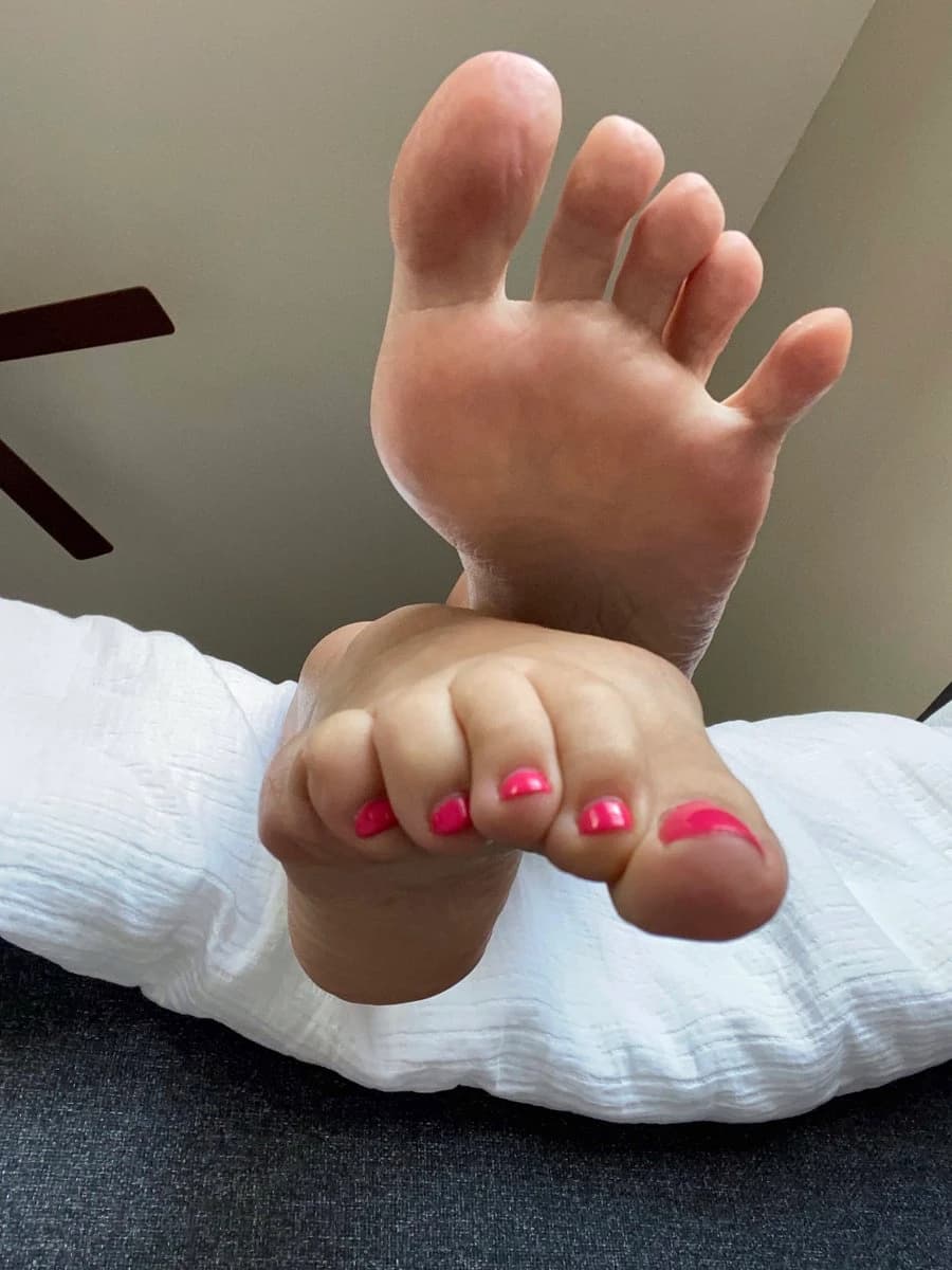 Close-up of wet feet near pool edge, shimmering water reflections, sensual summer feet image